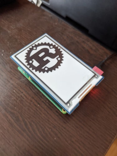 Rust logo displayed on the e-paper display
